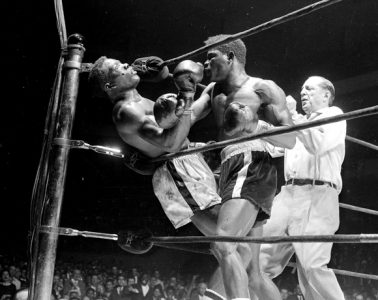 UNITED STATES - MARCH 24: Emile Griffith vs Benny Paret, Benny (Kid) Paret lies helpless against ropes as flailing fists of Emile Gfriffith batter him into unconsciousness during twelfth round of their welterweight championship fight at the Garden . Ref Ruby Goldstein pulled Griffith off the champ who slumped to the canvas. It was ruled a TKO at 2:09 of the twelfth. paret was removed, still unconscous, to Roosevelt Hospital after getting last rites in dressing room. (Photo by Charles Hoff/NY Daily News Archive via Getty Images)